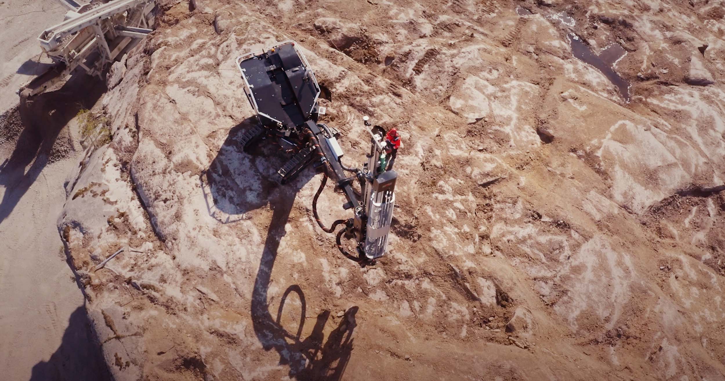 Stonepower Stone Spider drill rig working on a sand colored rock